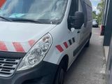the white van is parked in the parking lot next to the building