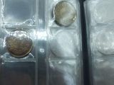 a lot of silver and gold coins in a case