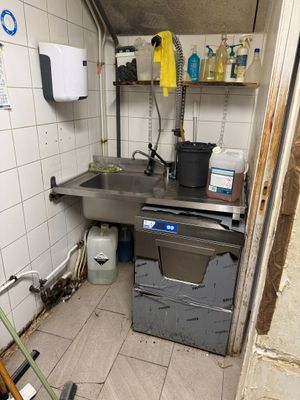 a small kitchen with a sink and a dishwasher