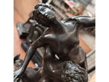 bronze statue of a woman holding a child in her arms