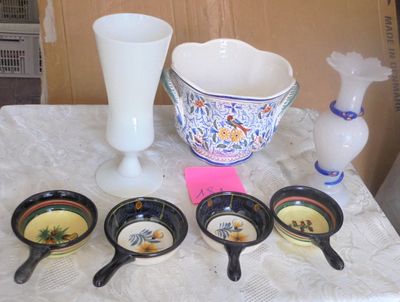 several bowls and spoons are sitting on a table with a vase in the background