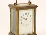 a small clock that is sitting on top of a table