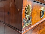a wooden chest of drawers with a marble top