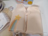 a small child ' s swim vest with a star on it