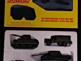 a box with a toy army vehicle and other items in it