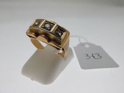 an image of a gold ring with black and white stones