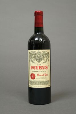 a bottle of red wine sitting on top of a table