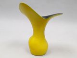 a yellow vase with a black handle on a white background