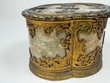 a gold and marble box on a white surface