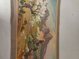 a painting hanging on the wall next to a vase