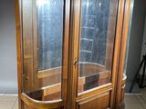 a large wooden cabinet with a glass door on it