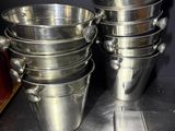 many pots and pans sitting on a shelf