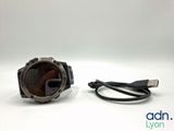 a close up of a watch with a cable connected to it