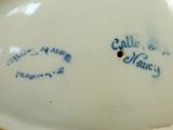 a close up of a white plate with blue writing on it