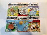six books of french comics on a white surface