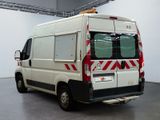 a white van with red stripes parked in a room