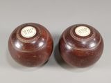 une paire de vases marron posés sur une surface grise