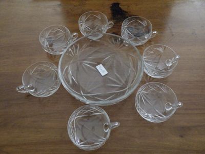 a lot of glass cups and saucers sitting on a table