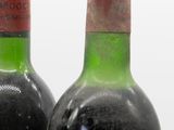 two bottles of wine sitting next to each other on a table
