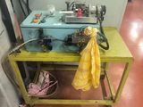 a yellow table with a blue machine on it
