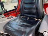 a black seat on the back of a red truck