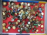 a box full of assorted buttons on a red surface