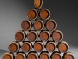 wooden wine barrels stacked on top of each other in a pyramid