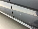 a close up of a car ' s door handle and the side of the car