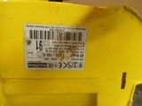 a close up of a yellow machine with a barcode on it