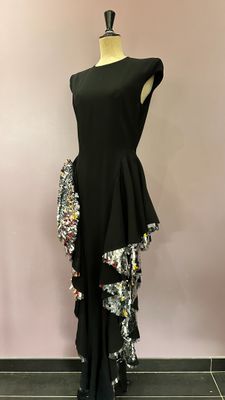a black dress with sequins and sequins on a mannequin mannequin