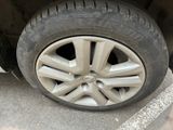 a tire that is sitting on the ground next to a car