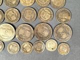 several different types of coins are arranged on a table