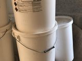 several buckets are stacked on top of each other in a room