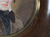 portrait of a young man in a brown coat and black bow tie