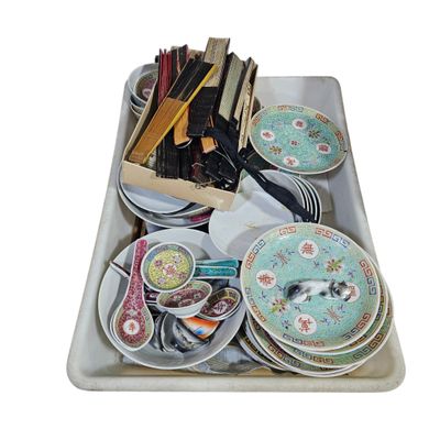 a tray full of plates and utensils on a table