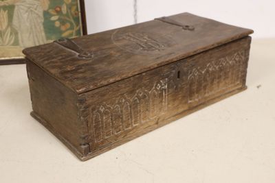 an old wooden box sitting on a table next to a framed picture