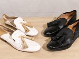 two pairs of women ' s shoes with tassels on a wooden surface