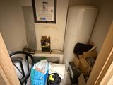 a small room with a toilet and a trash can in it