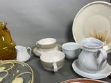 many different types of dishes and cups on the table