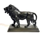 bronze statue of a lion on a marble base on a white background