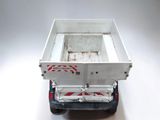 a white dump truck with a red and white stripe on the back of it