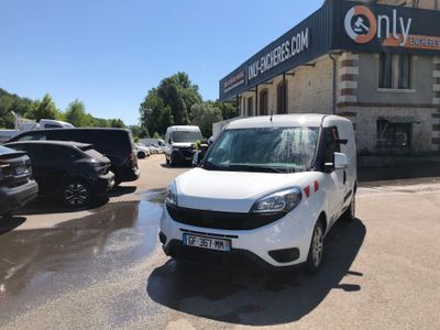 a small white van parked in front of a building