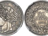 a silver coin with a woman ' s head and laurels on it