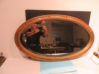 a woman taking a picture of herself in a mirror
