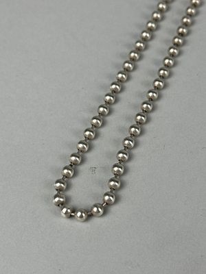 a close up of a metal ball chain on a table