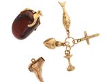 une image représentant un collier en or orné d'une pierre rouge et d'une croix
