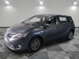 the toyota sienna is parked on a checkered floor in a garage