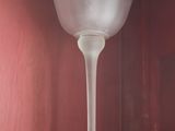 a glass vase sitting on top of a shelf in a cabinet
