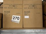 several boxes of wine glasses are stacked on a shelf