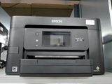 a printer that is sitting on a shelf in a room